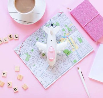 travel-wooden-blocks-map-paper-tea-cup-pen-diary-airplane-white-surface